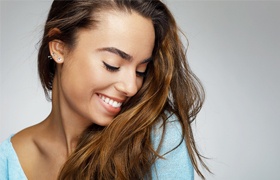 Woman with dental crown restoration smiling