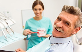 Patient learning about dental implants in DeLand with a dentist