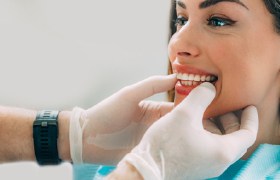 Closeup of dentist evaluating mouth during emergency dentistry visit