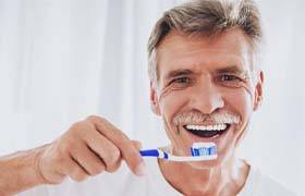 senior man brushing his teeth