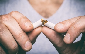 Man breaking a cigarette in half