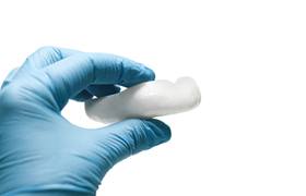 Dental implant dentist in DeLand holding a mouthguard