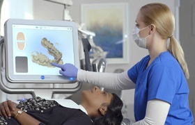 Dentist and patient looking at iTero scanner digital impressions