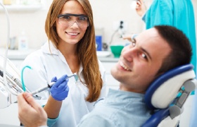 Smiling man in dental chair after custom nightguard fitting