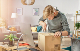 man opening a package with a knife 