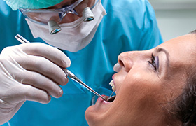 Patient receiving preventive dentistry checkup and teeth cleaning