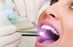 Woman receiving oral cancer screening