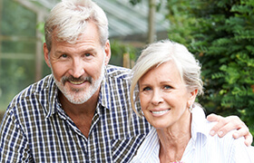 Older man and woman smiling after dentistry for seniors visit