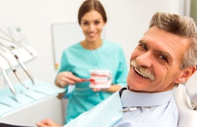 Man smiles at his DeLand dental implant dentist