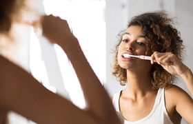 Teenager with dental sealants brushing teeth