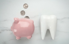 tooth and piggy bank for smile makeover in DeLand