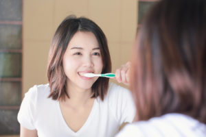 Young woman brushing teeth