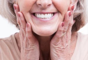 a woman smiling with her new dentures