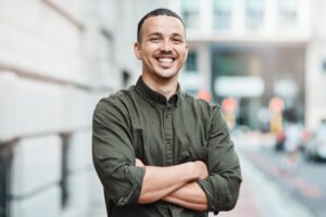 Man smiling with arms crossed.